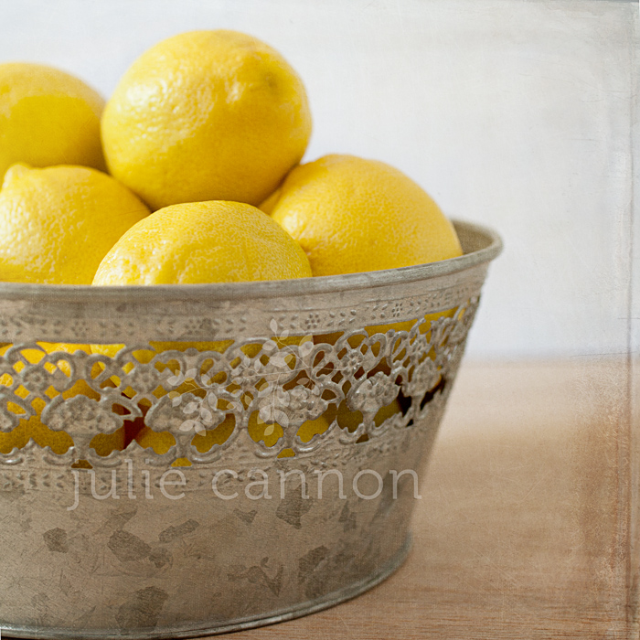 Lemons in tin bowl square crop
